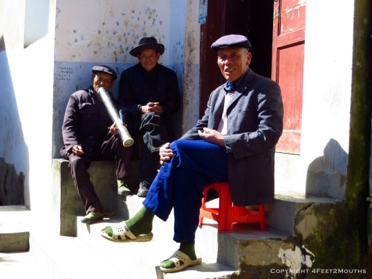 Men smoking a tobacco water pipe in Shang Village.